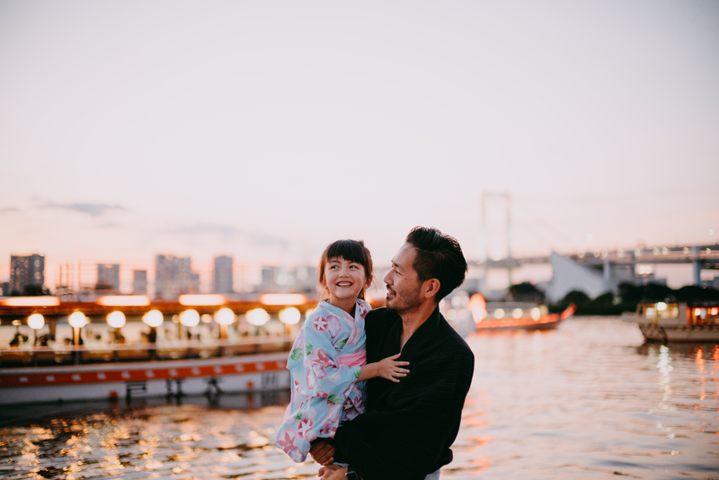 Japanese father and preschool daughter wearing kimono on boat, Tokyo - Getty Images