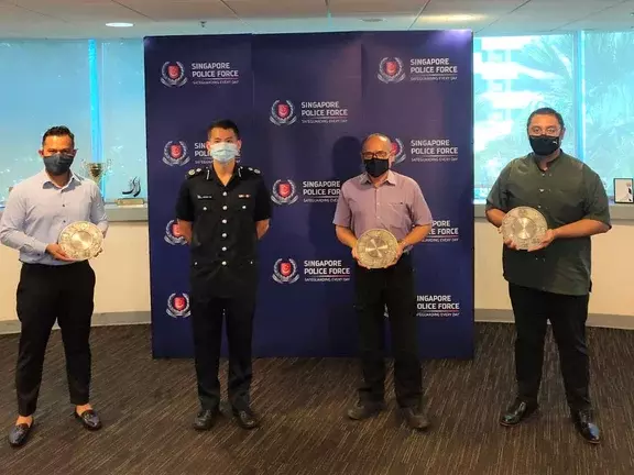 Assistant Commissioner of Police Gregory Tan Siew Hin, commander of Central Police Division, (2nd from left) with Noralimin Mawi (1st right) and 2 other recipients of the Public Spiritedness Award.