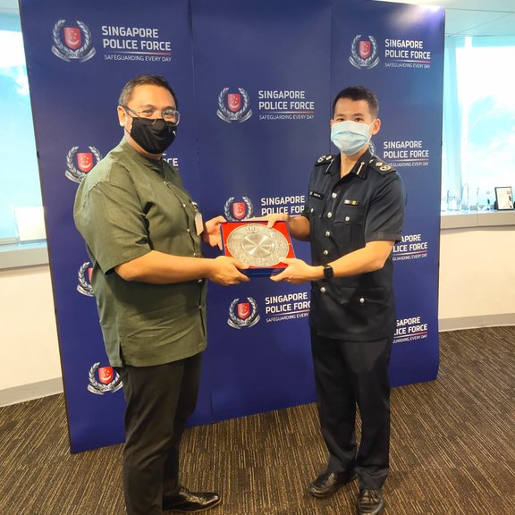 Assistant Commissioner of Police Gregory Tan Siew Hin, commander of Central Police Division, (right) presenting the Public Spiritedness Award to Noralimin Mawi (left).